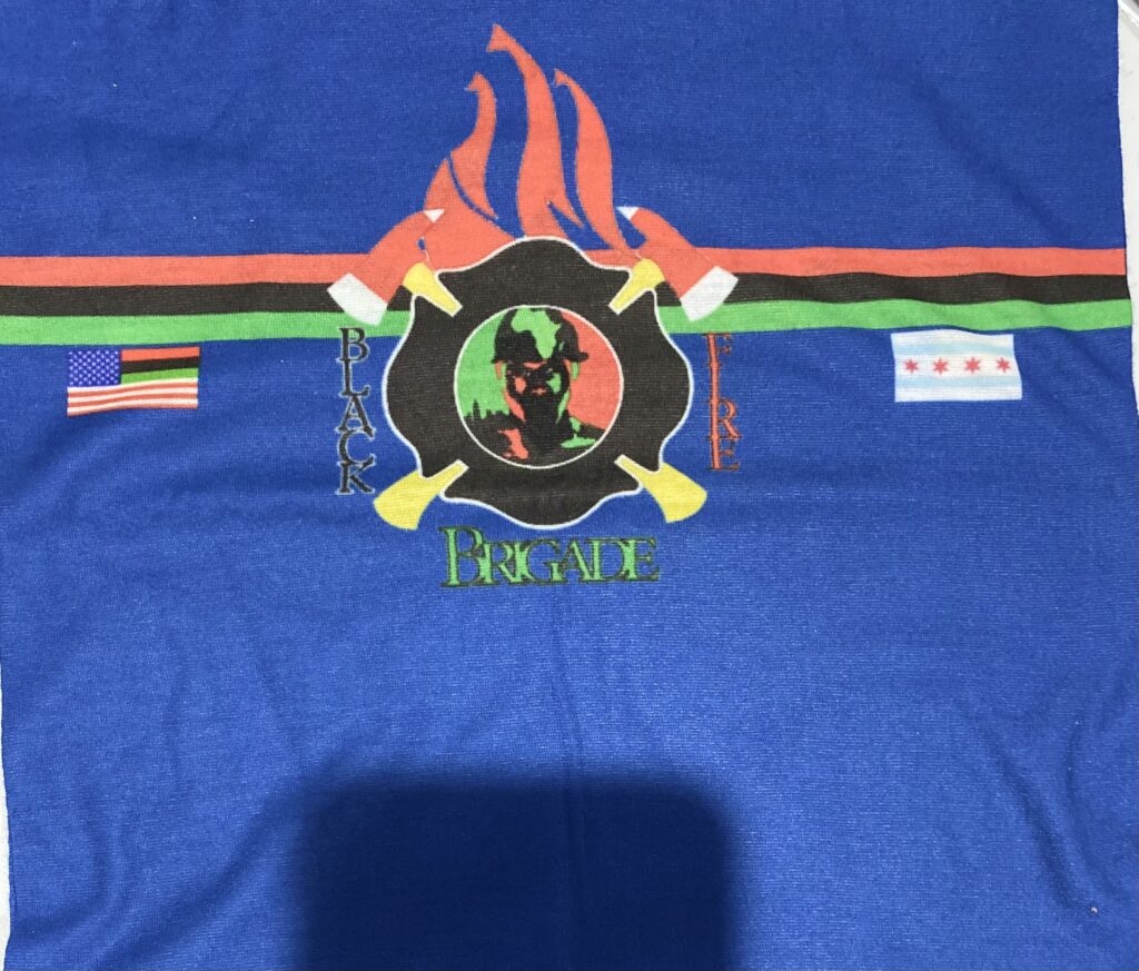 A blue shirt with a fire and flames on it.